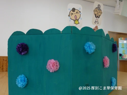 司会の先生がペープサート「いないいないばあちゃん」を披露している様子