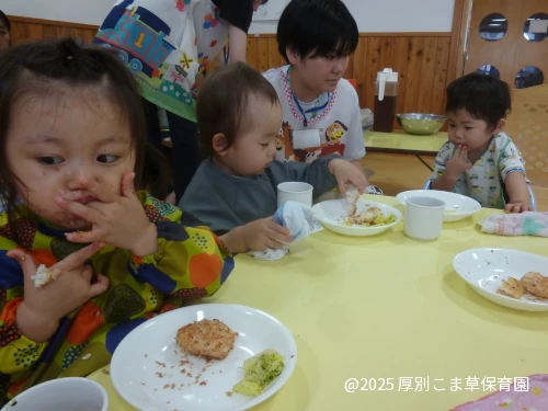 昼食を食べている１歳児のお子さまの様子