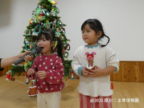 あさがお組（３歳児）の子どもたちがツリーの飾りつけの制作発表をしている様子