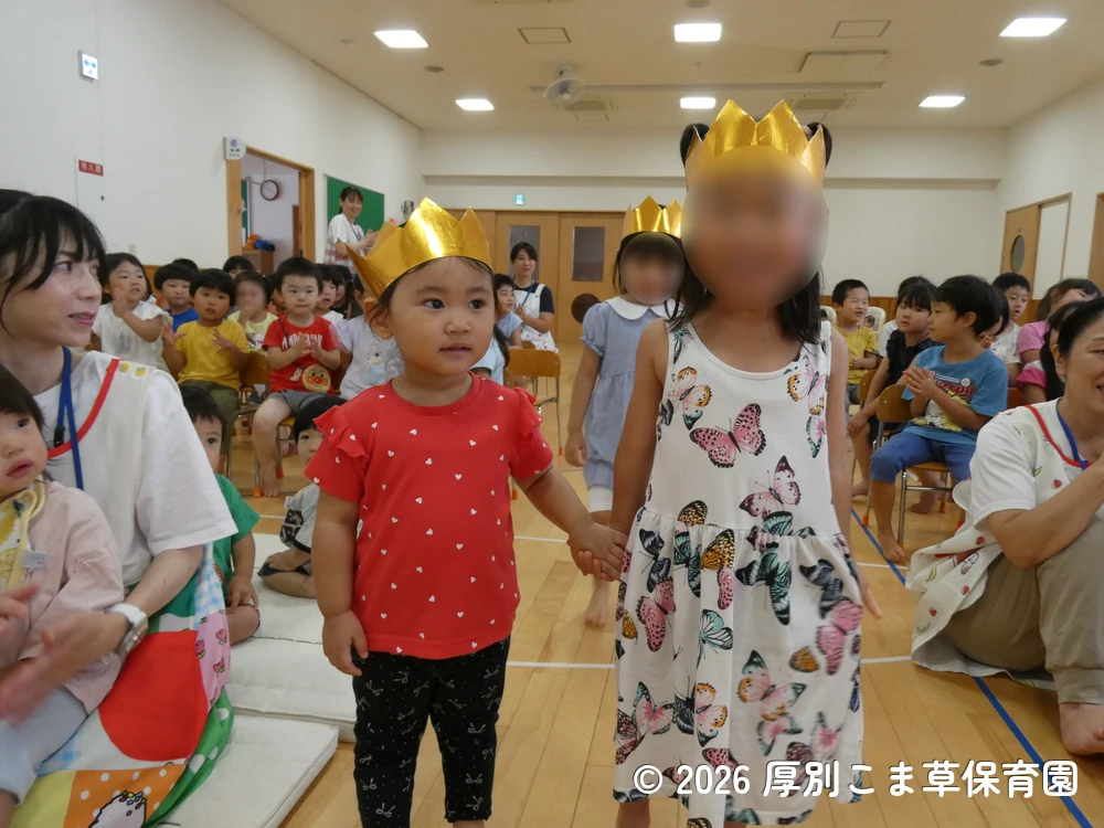 音楽に合わせて色々な表情を見せながら入場する誕生児の子どもたちの様子