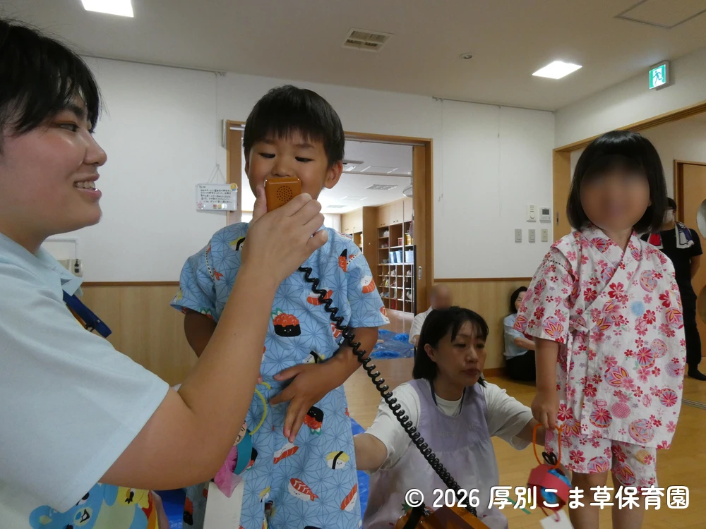 七夕飾りつけ制作の内容を発表するあさがお組(3歳児)の子どもたちの様子